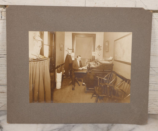 Lot 081 - Antique Boarded Occupational Photograph Of Man In His Office With Map, Sextant, And Telephone Visible In Photo