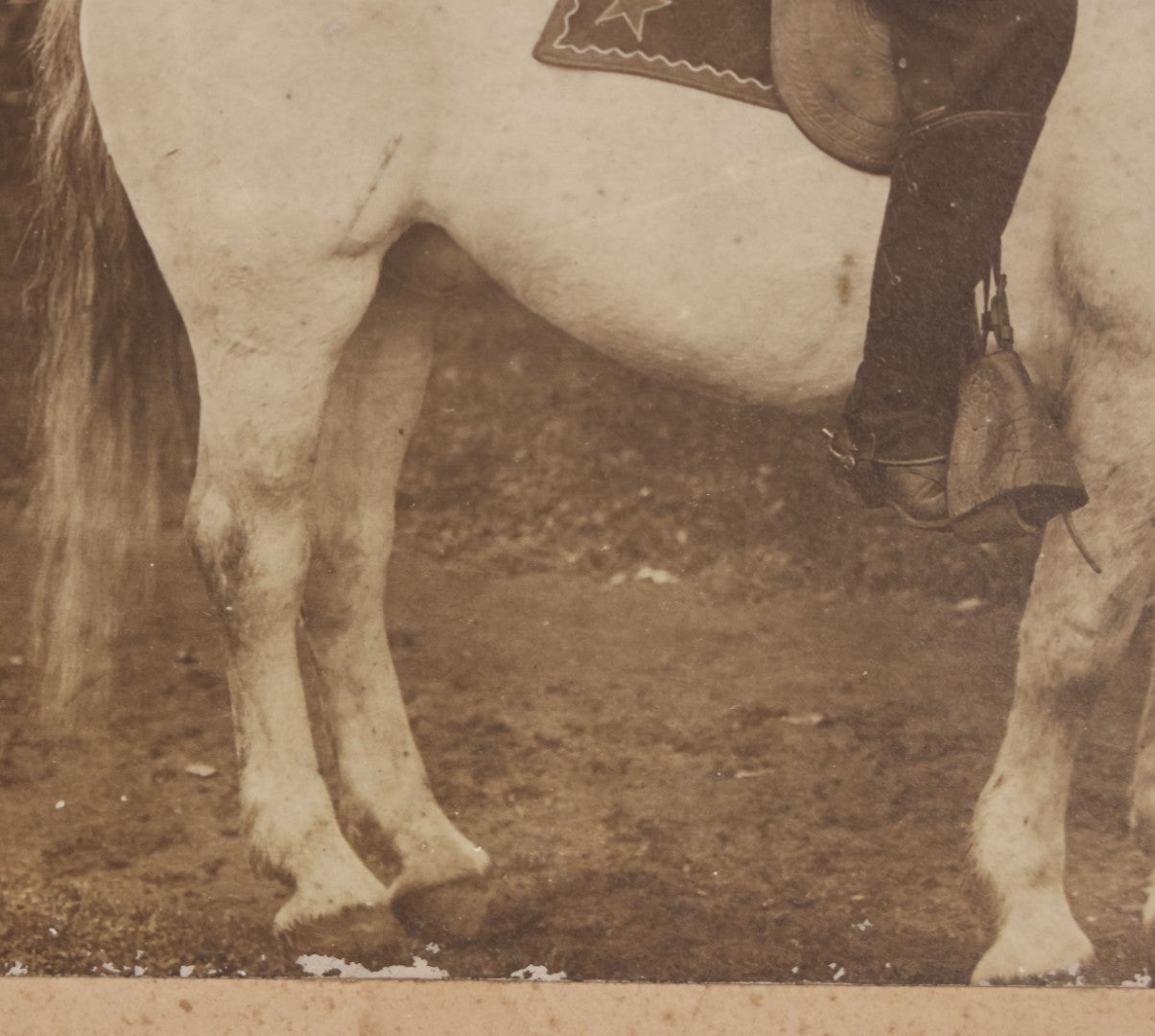 Lot 083 - Antique Boarded Photograph Of Man In Uniform Sitting Horseback On White Horse With Saddle Blanket Emblazoned With Star, Western Hat And Badge