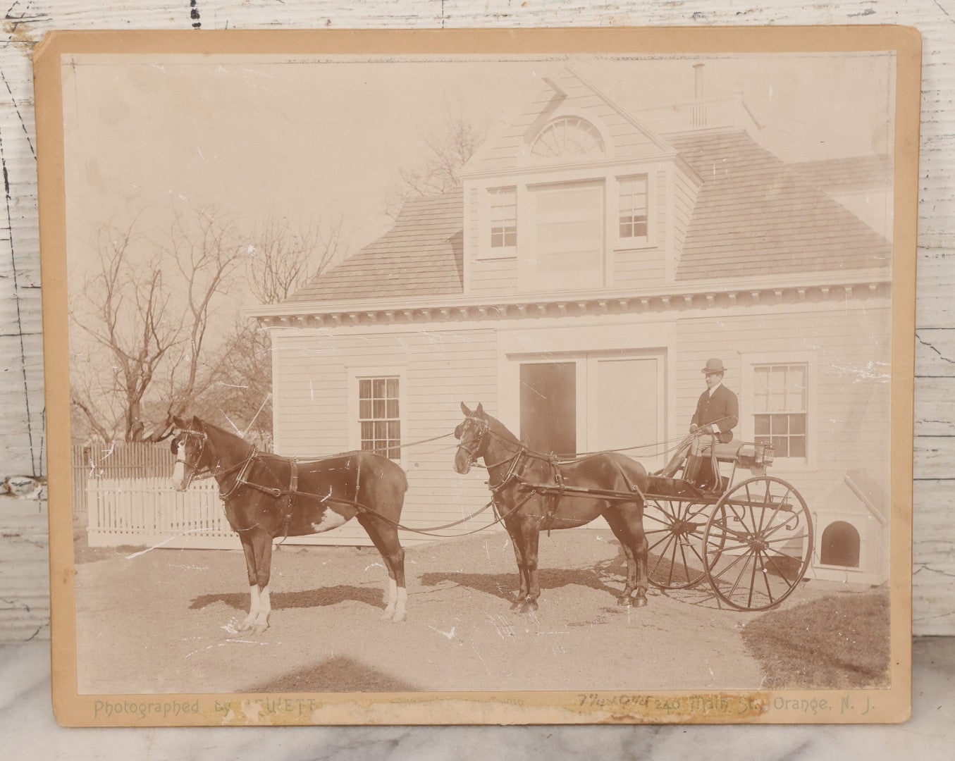 Lot 084 - Antique Boarded Photograph Of Man Sitting In Horsedrawn Carriage With Two Horses In Front Of A Home With Doghouse, Photographed By Jewett, Orange, New Jersey