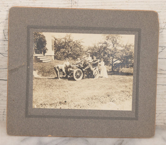 Lot 089 - Antique Boarded Photograph Of Group Of People Posing With And Starting An Early Automobile