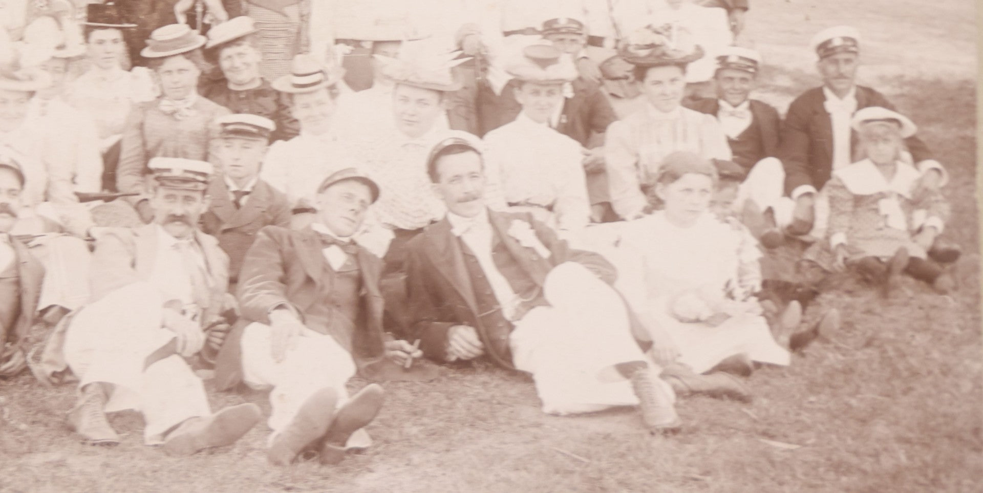 Lot 107 - Antique Double Sided Boarded Photograph Of Outing Of Fancy Dressed Men In White Pants, White Caps, With Ribbons And Their Wives