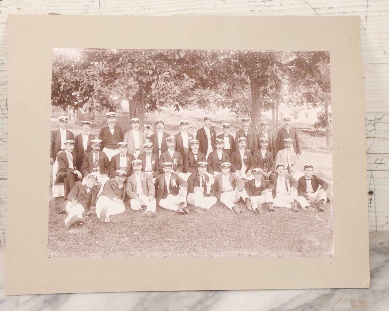 Lot 107 - Antique Double Sided Boarded Photograph Of Outing Of Fancy Dressed Men In White Pants, White Caps, With Ribbons And Their Wives