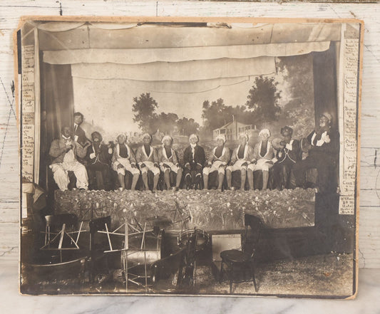 Lot 110 - Antique Boarded Photograph Of Stage Performers In Costume With Painted Backdrop And Drum Set, Music Stands In Foreground