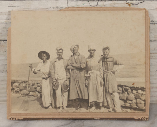 Lot 113 - Small Antique Boarded Photograph Of Five Men Goofing Off In Silly Costumes, Wearing Kitchen Pots And Pans As Hats, Pan Lids As Symbols, Standing In Front Of Rock Wall On Shore, Note Board Is Trimmed