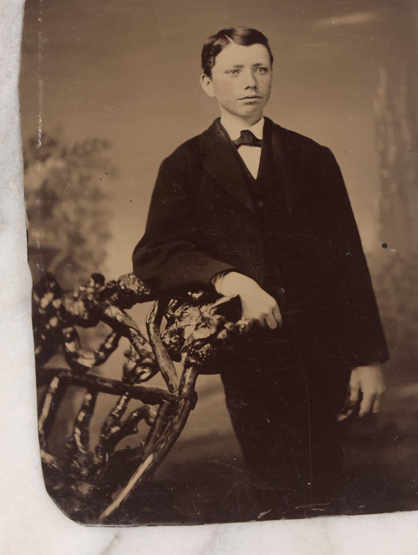 Lot 132 - Grouping Of Ten Antique Tintype Photographs Including Half Plate Of Boy Leaning Against Branch Chair, Young Man With Bowtie, Gaunt Woman With Jewelry, Middle Aged Couple, Mother And Son, And More