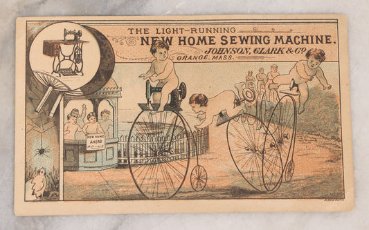 Lot 163 - Antique Lithographed Trade Card For The Light-Running New Home Sewing Machine By Johnson, Clark & Co., Orange, Massachusetts, With Babies Riding High Wheel Bicycles