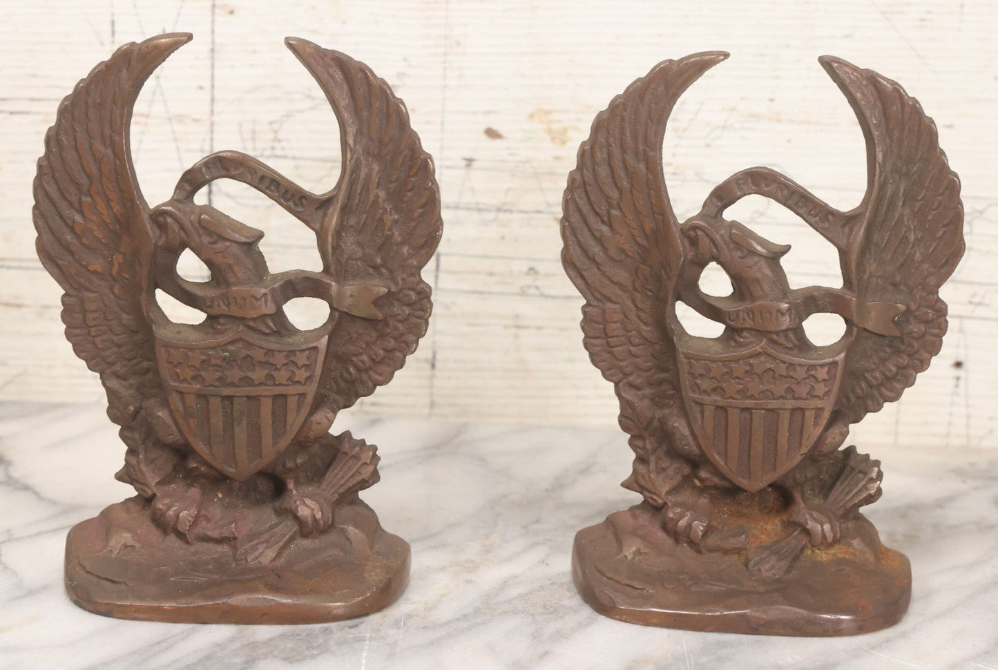 Lot 023 - Pair Of Vintage Bronzed Cast Iron Bookends With Patriotic Eagle Clutching Olive Branch And Arrows, With Shield And "E. Pluribus Unum" Banner