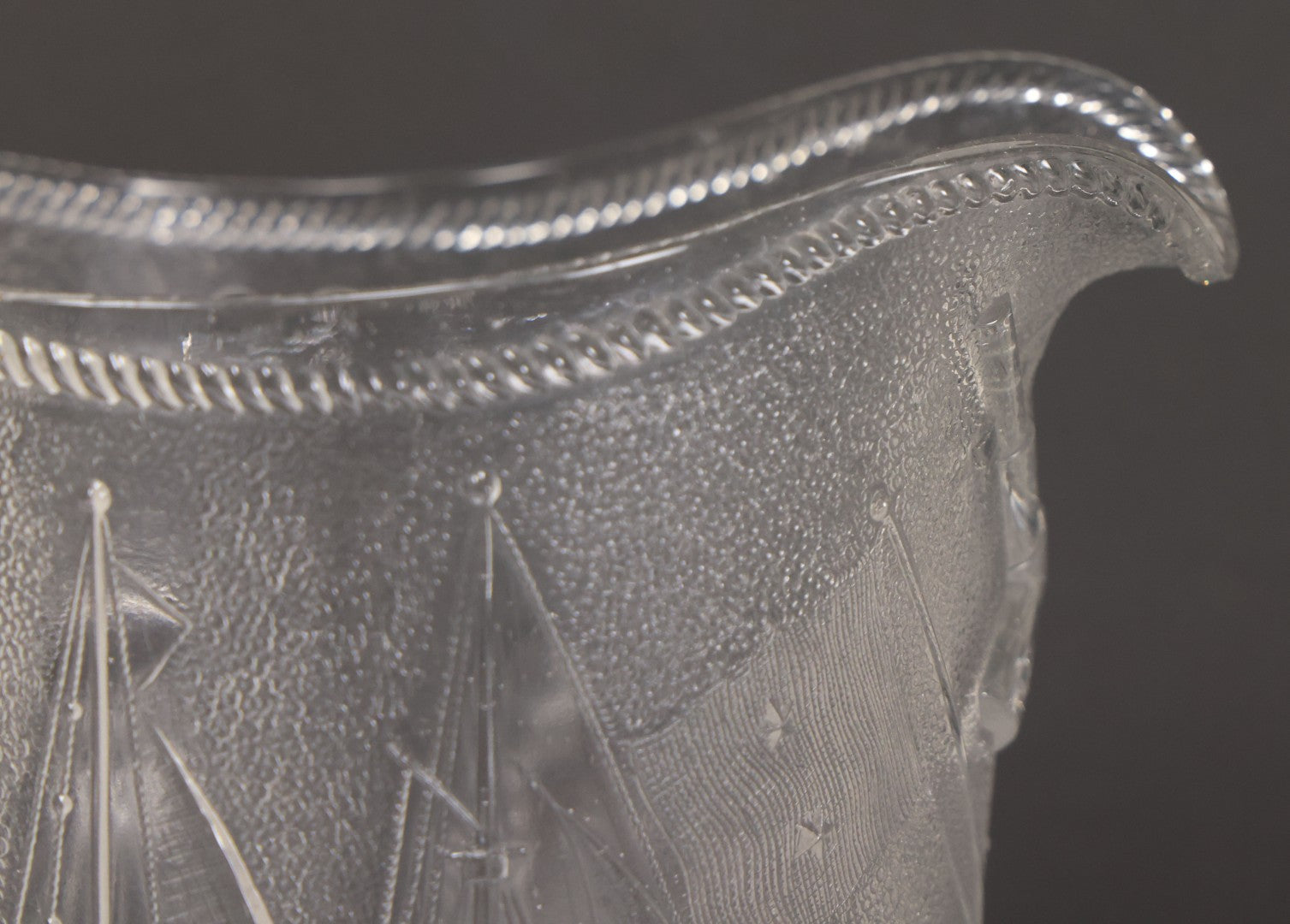 Lot 027 - Antique Early American Pattern Glass E.A.P.G. Spanish American War Battle Of Manila Bay Commemorative Pitcher With Admiral Dewey And U.S.S. Olympia, Patriotic Symbols Including Weaponry And Flags, Manufactured By Beatty-Brady Glass Co., Indiana