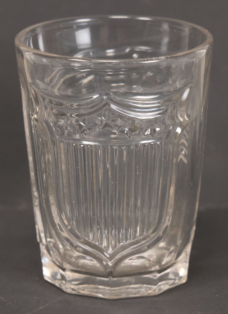Lot 028 - Vintage American Pattern Glass Drinking Cup With American Flag, Patriotic Shield, And Rifle Motifs