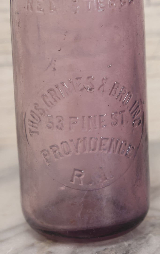 Lot 032 - Antique Purple Glass Bottle From Thos. Grimes & Bro. Inc., Providence, Rhode Island, 9" Height