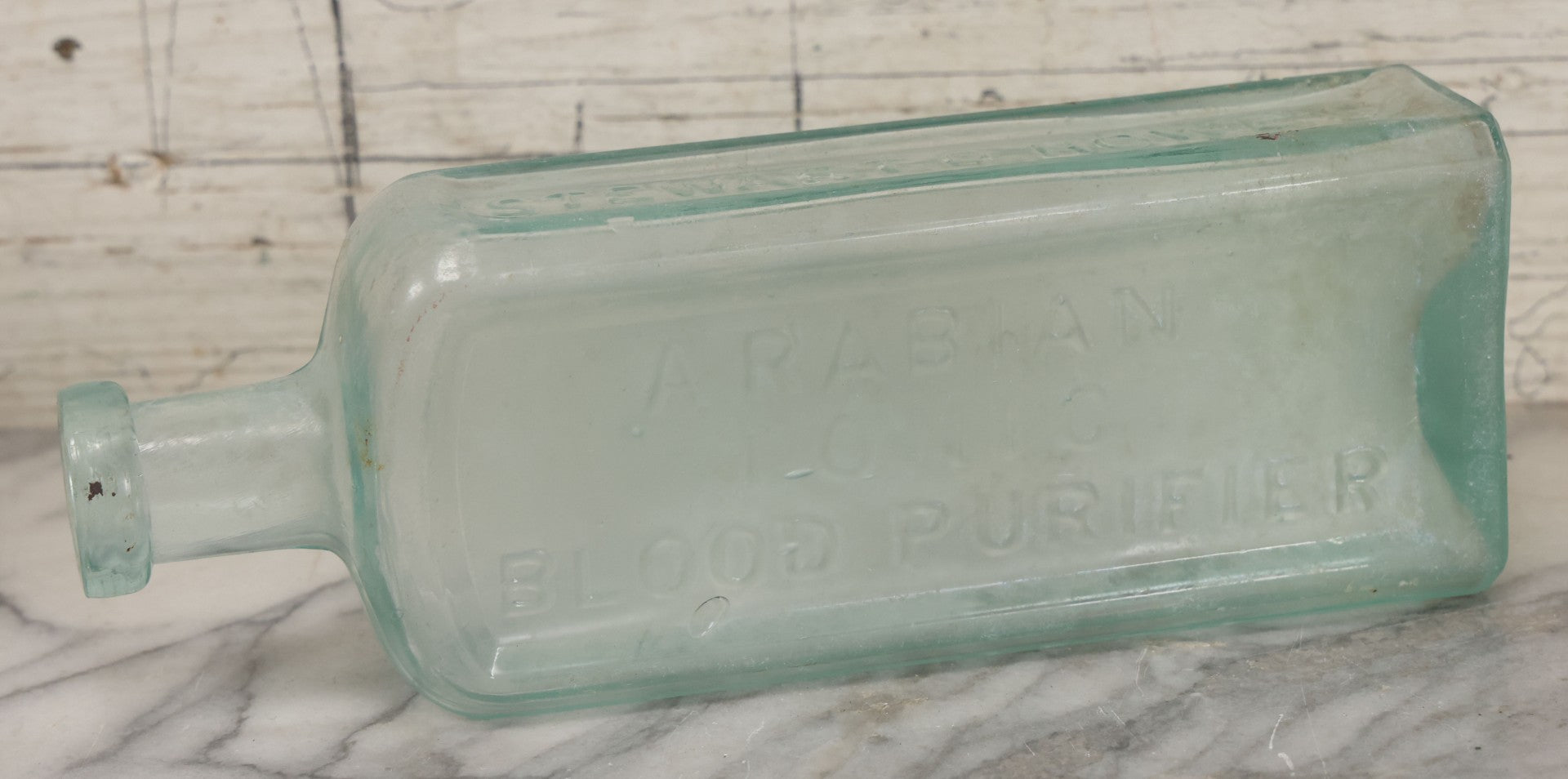 Lot 033 - Antique Stewart D. Howe's Arabian Tonic Blood Purifier Patent Medicine Apothecary Glass Bottle, New York, With Embossed Lettering, 9-3/8" Height