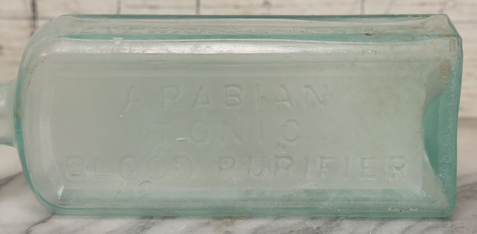 Lot 033 - Antique Stewart D. Howe's Arabian Tonic Blood Purifier Patent Medicine Apothecary Glass Bottle, New York, With Embossed Lettering, 9-3/8" Height