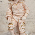Lot 037 - Vintage Bisque Statue Of Young Blond Child In Large Straw Hat Sitting By Shore With Pail, With Pink Painted Details And Gold Embellishments, Note Chip, Repairs, 12" Height