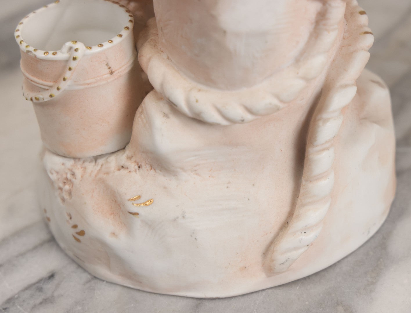 Lot 037 - Vintage Bisque Statue Of Young Blond Child In Large Straw Hat Sitting By Shore With Pail, With Pink Painted Details And Gold Embellishments, Note Chip, Repairs, 12" Height