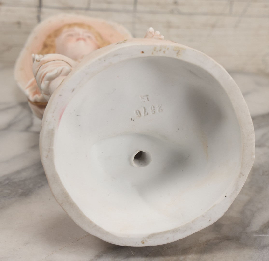 Lot 037 - Vintage Bisque Statue Of Young Blond Child In Large Straw Hat Sitting By Shore With Pail, With Pink Painted Details And Gold Embellishments, Note Chip, Repairs, 12" Height