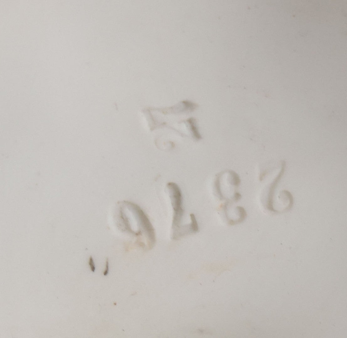 Lot 037 - Vintage Bisque Statue Of Young Blond Child In Large Straw Hat Sitting By Shore With Pail, With Pink Painted Details And Gold Embellishments, Note Chip, Repairs, 12" Height