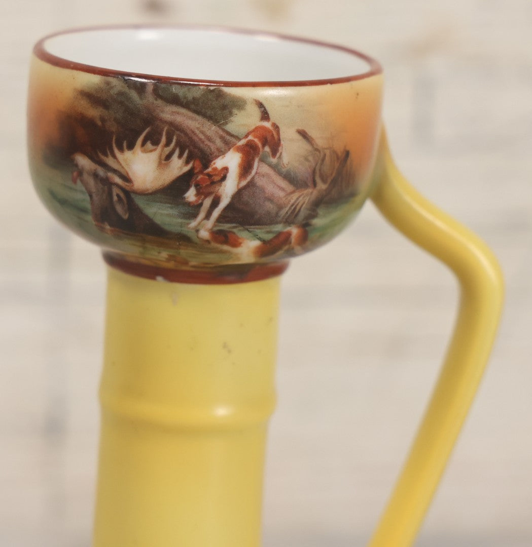 Lot 038 - Antique Yellow Painted Candlestick With Hunting Dogs Attacking Swimming Moose Motif, Manufactured By Royal Bayreuth, Bavaria, 5-3/8" Height