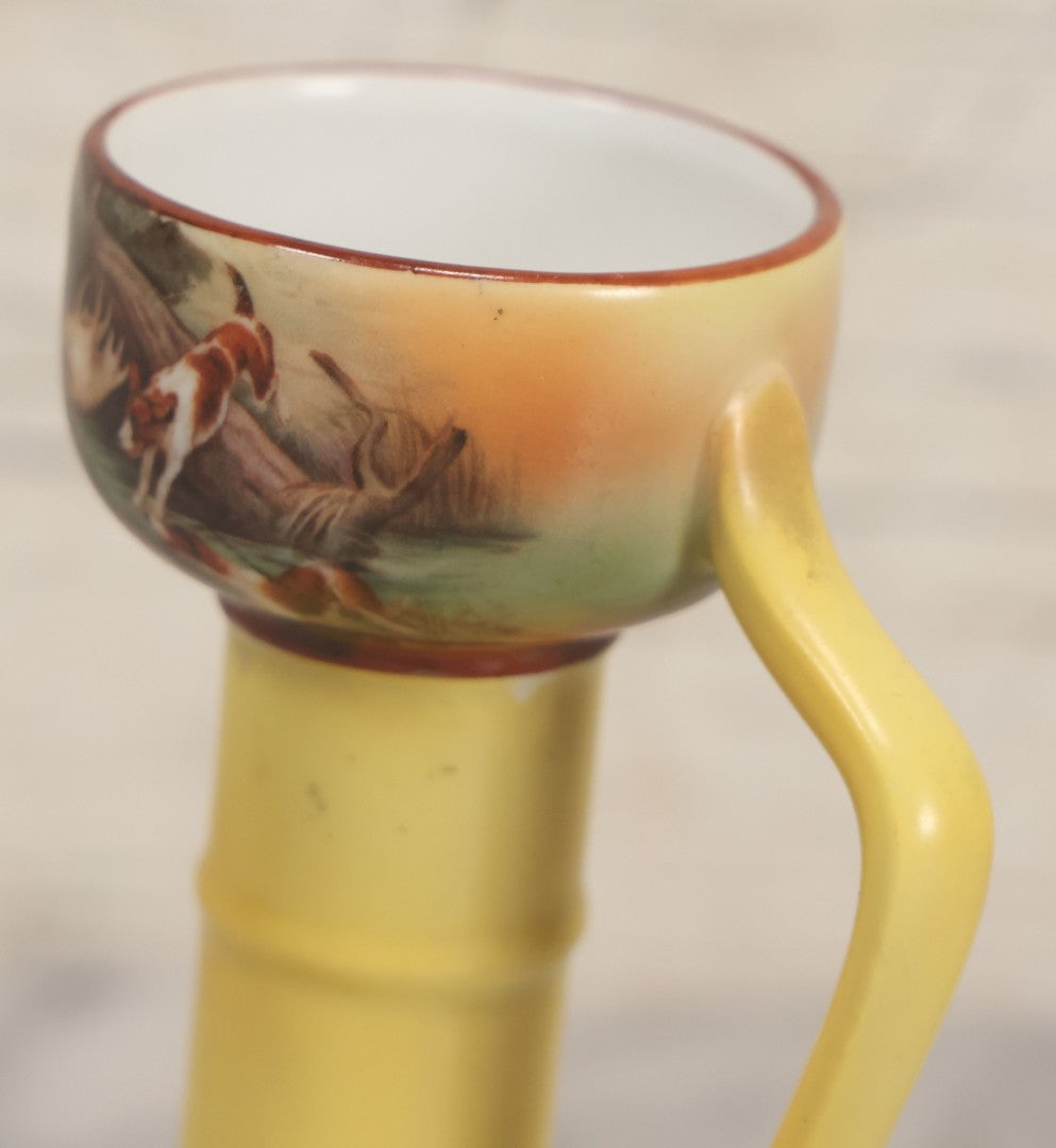 Lot 038 - Antique Yellow Painted Candlestick With Hunting Dogs Attacking Swimming Moose Motif, Manufactured By Royal Bayreuth, Bavaria, 5-3/8" Height
