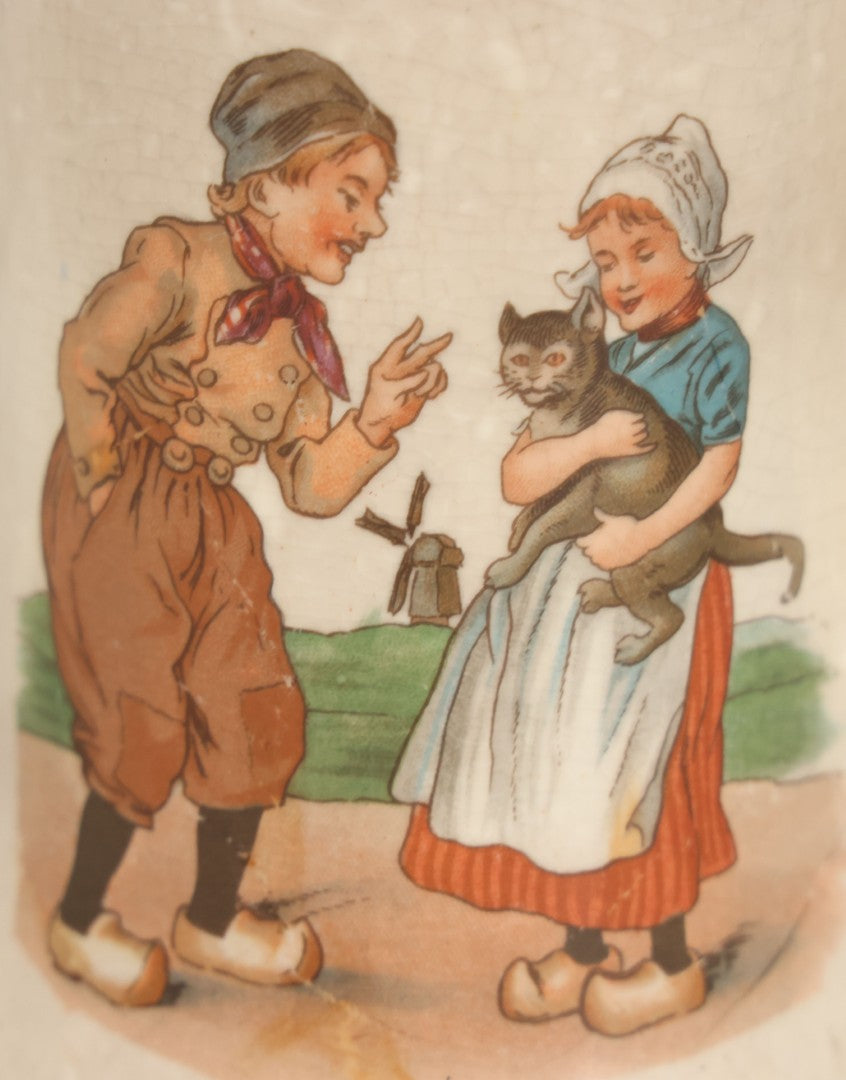 Lot 040 - Pair Of Antique Mugs With Image Of Dutch Children In Clogs Playing With Their Kitten, Windmill In Background