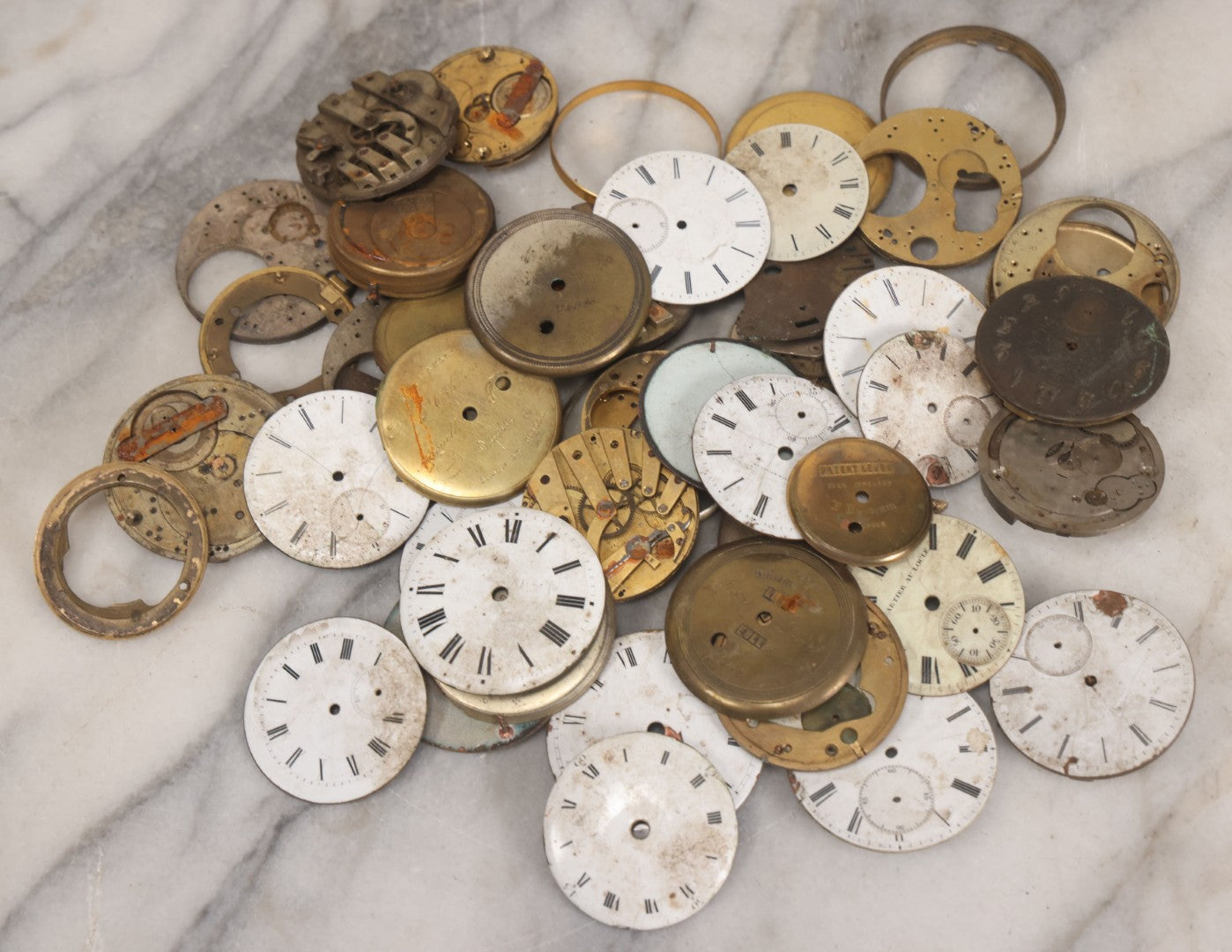 Lot 048 - Mixed Antique Salvage Grouping Of Pocket Watch Parts Including Porcelein Clock Faces, Movements, And Case Parts, 35+ Pieces, Makers Include J.F. Cooper, William Favre, F. Huquenm, M.J. Tobias