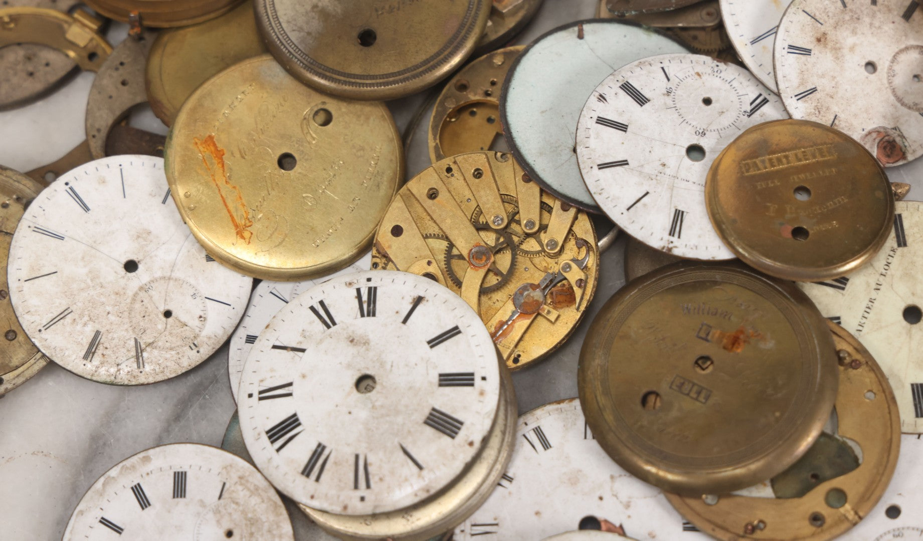 Lot 048 - Mixed Antique Salvage Grouping Of Pocket Watch Parts Including Porcelein Clock Faces, Movements, And Case Parts, 35+ Pieces, Makers Include J.F. Cooper, William Favre, F. Huquenm, M.J. Tobias