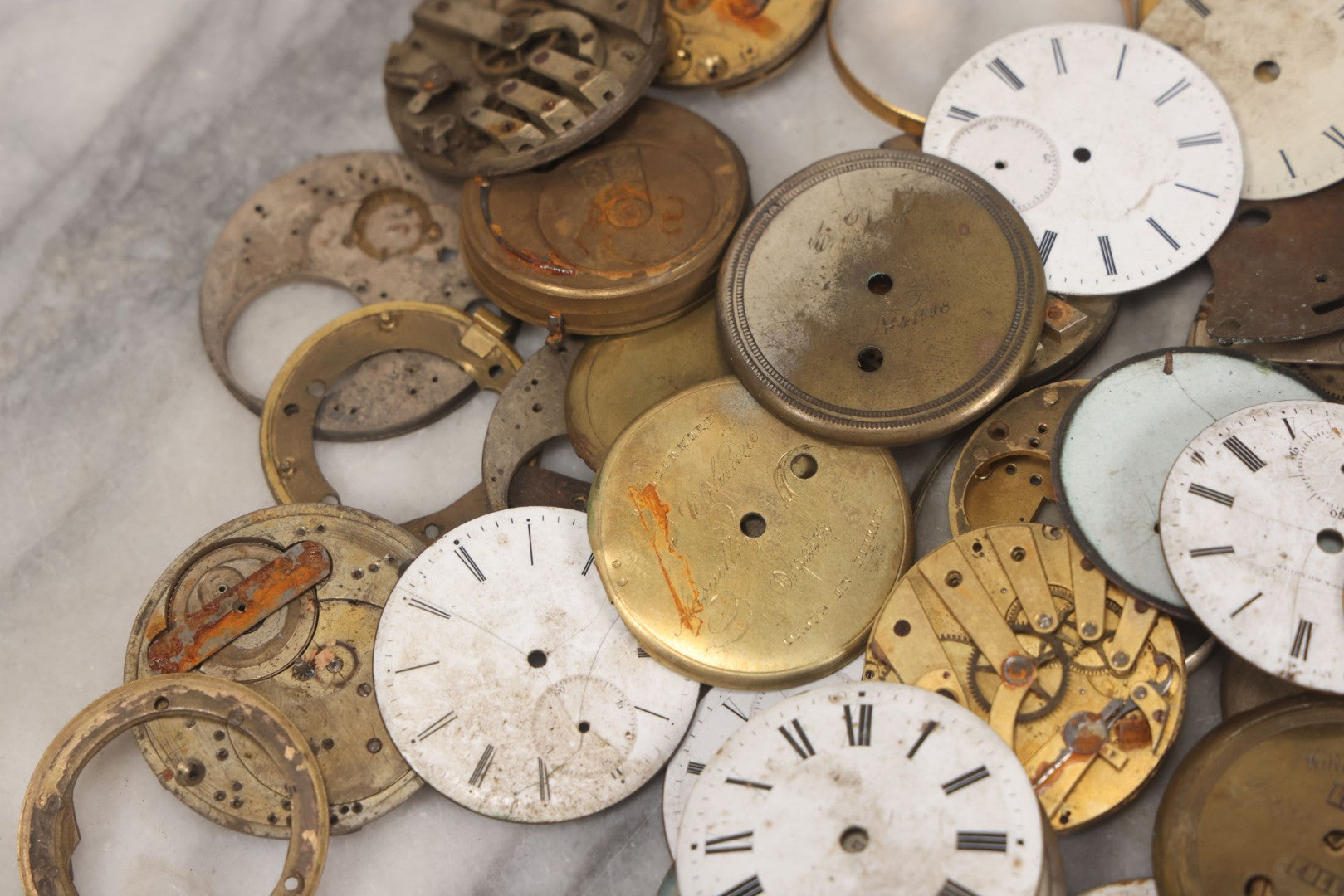 Lot 048 - Mixed Antique Salvage Grouping Of Pocket Watch Parts Including Porcelein Clock Faces, Movements, And Case Parts, 35+ Pieces, Makers Include J.F. Cooper, William Favre, F. Huquenm, M.J. Tobias