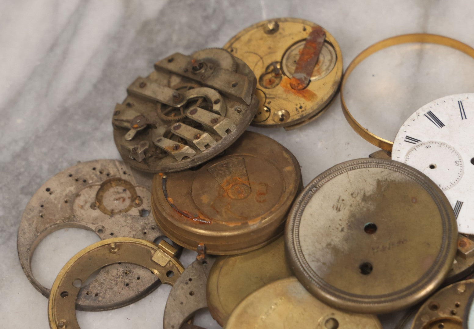 Lot 048 - Mixed Antique Salvage Grouping Of Pocket Watch Parts Including Porcelein Clock Faces, Movements, And Case Parts, 35+ Pieces, Makers Include J.F. Cooper, William Favre, F. Huquenm, M.J. Tobias