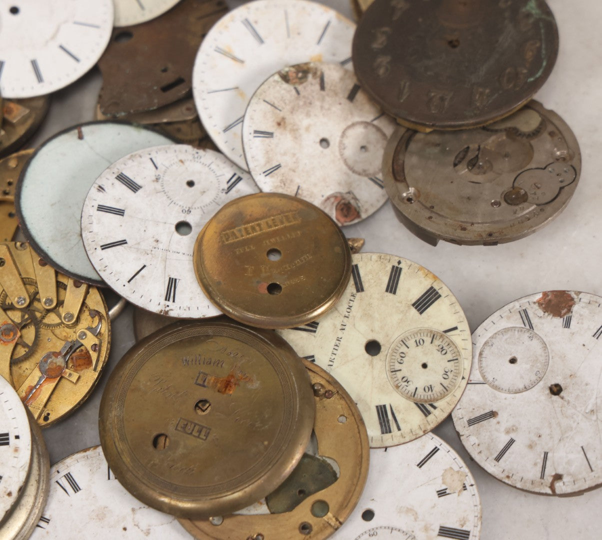 Lot 048 - Mixed Antique Salvage Grouping Of Pocket Watch Parts Including Porcelein Clock Faces, Movements, And Case Parts, 35+ Pieces, Makers Include J.F. Cooper, William Favre, F. Huquenm, M.J. Tobias