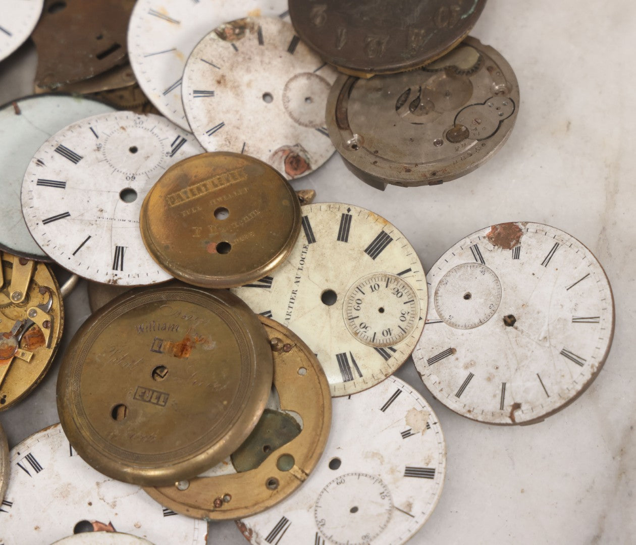 Lot 048 - Mixed Antique Salvage Grouping Of Pocket Watch Parts Including Porcelein Clock Faces, Movements, And Case Parts, 35+ Pieces, Makers Include J.F. Cooper, William Favre, F. Huquenm, M.J. Tobias