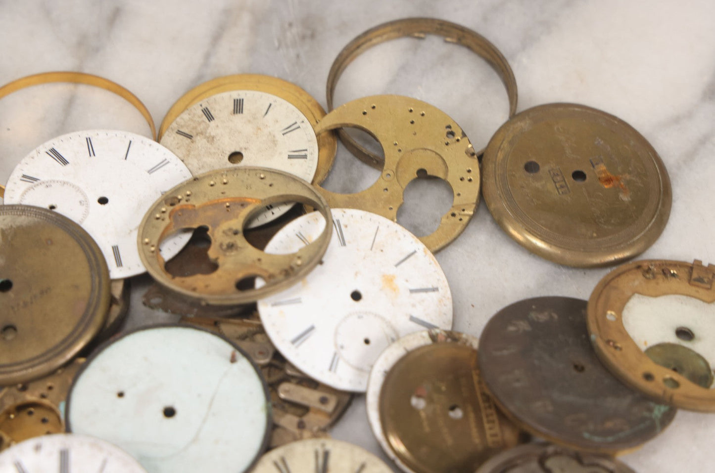 Lot 048 - Mixed Antique Salvage Grouping Of Pocket Watch Parts Including Porcelein Clock Faces, Movements, And Case Parts, 35+ Pieces, Makers Include J.F. Cooper, William Favre, F. Huquenm, M.J. Tobias