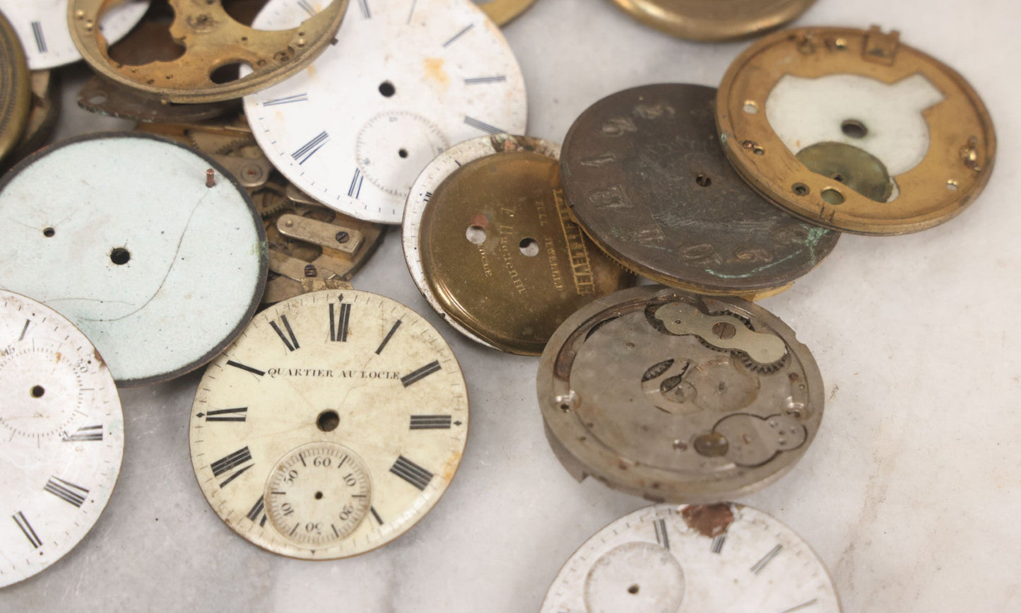 Lot 048 - Mixed Antique Salvage Grouping Of Pocket Watch Parts Including Porcelein Clock Faces, Movements, And Case Parts, 35+ Pieces, Makers Include J.F. Cooper, William Favre, F. Huquenm, M.J. Tobias