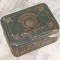 Lot 049 - Vintage Tin Lithograph Factory Agency Advertising Tin For Omega Watches, "The Watch Of Matchless Merit; Universally Guarenteed"