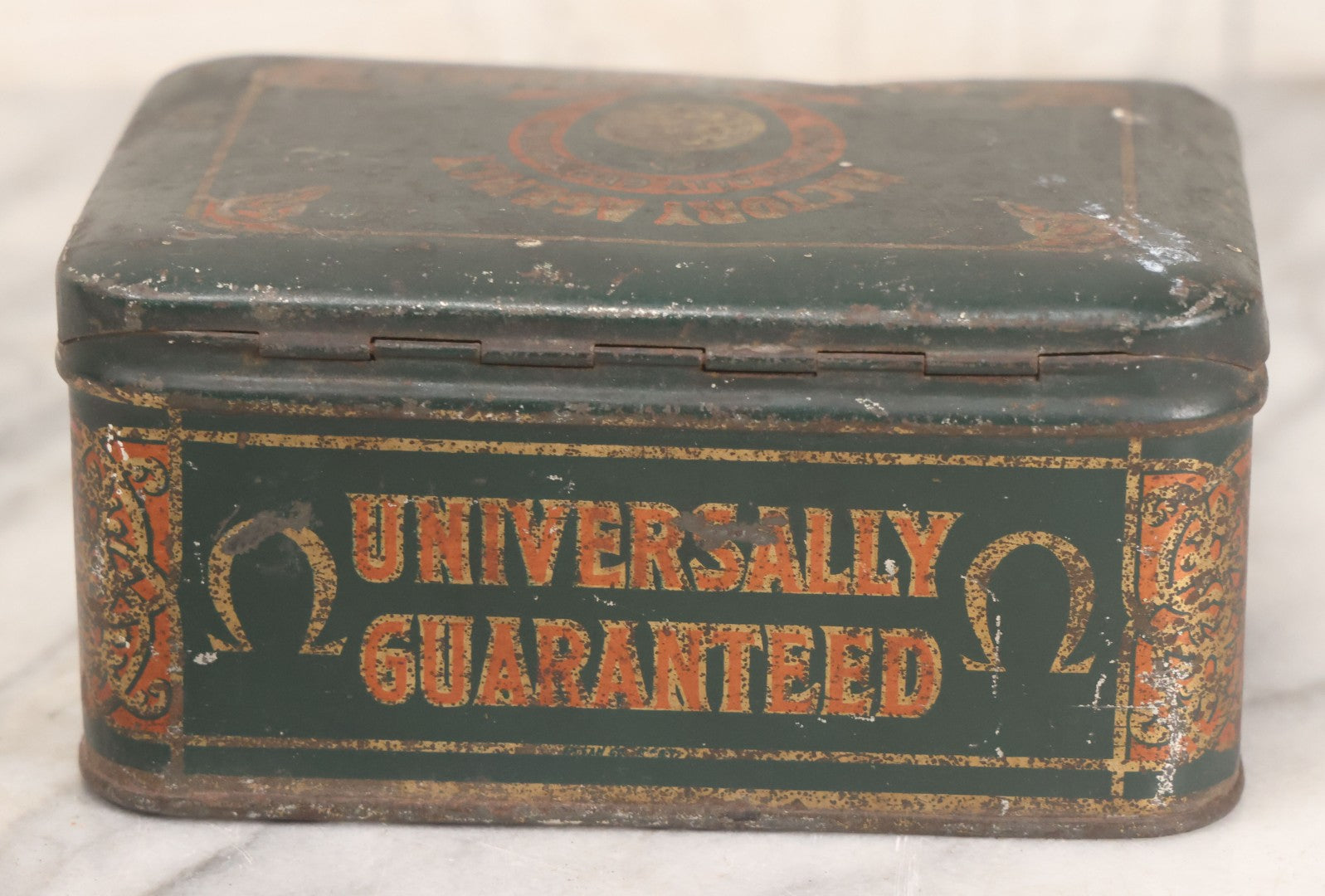 Lot 049 - Vintage Tin Lithograph Factory Agency Advertising Tin For Omega Watches, "The Watch Of Matchless Merit; Universally Guarenteed" 