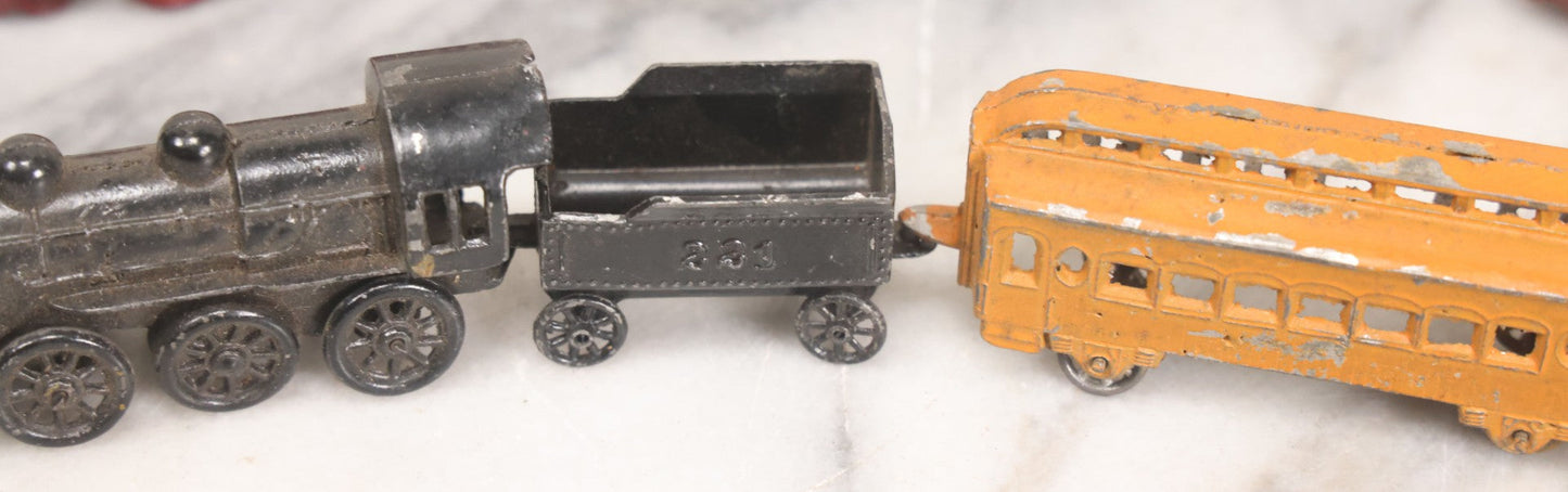 Lot 057 - Grouping Of Seven Vintage Prewar Diecast Train Toys With Original Paint, Including Two Locomotives, Two Tenders, Two Passenger Cars, And One Freight Car
