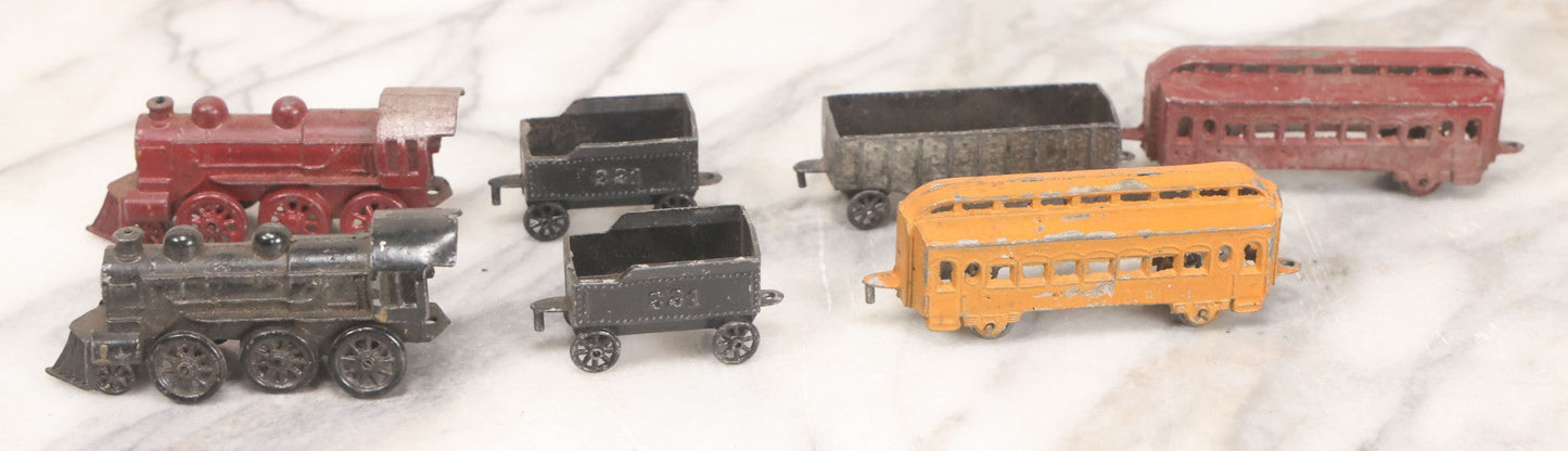 Lot 057 - Grouping Of Seven Vintage Prewar Diecast Train Toys With Original Paint, Including Two Locomotives, Two Tenders, Two Passenger Cars, And One Freight Car