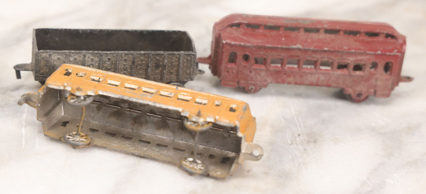 Lot 057 - Grouping Of Seven Vintage Prewar Diecast Train Toys With Original Paint, Including Two Locomotives, Two Tenders, Two Passenger Cars, And One Freight Car