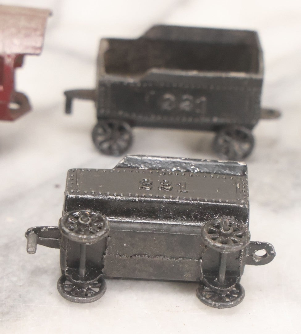 Lot 057 - Grouping Of Seven Vintage Prewar Diecast Train Toys With Original Paint, Including Two Locomotives, Two Tenders, Two Passenger Cars, And One Freight Car