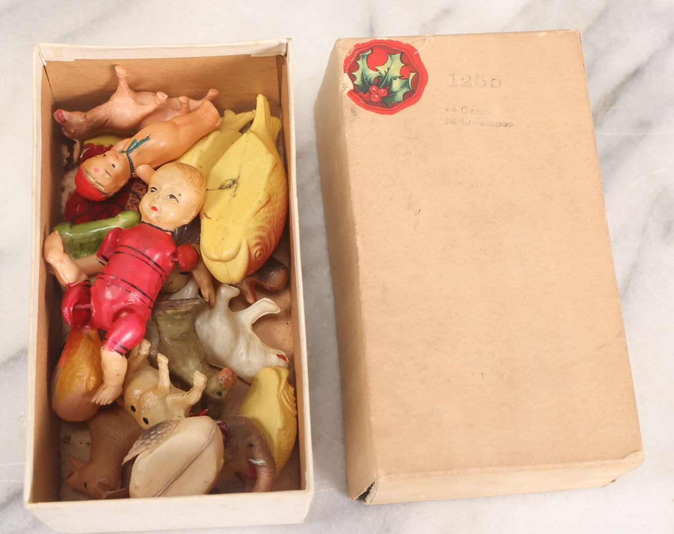 Lot 058 - Box Lot Grouping Of 19 Vintage Celluloid Dolls And Animal Toys Including Hippo, Elephant, Polar Bear, Camel, Donkey, Fish, And More