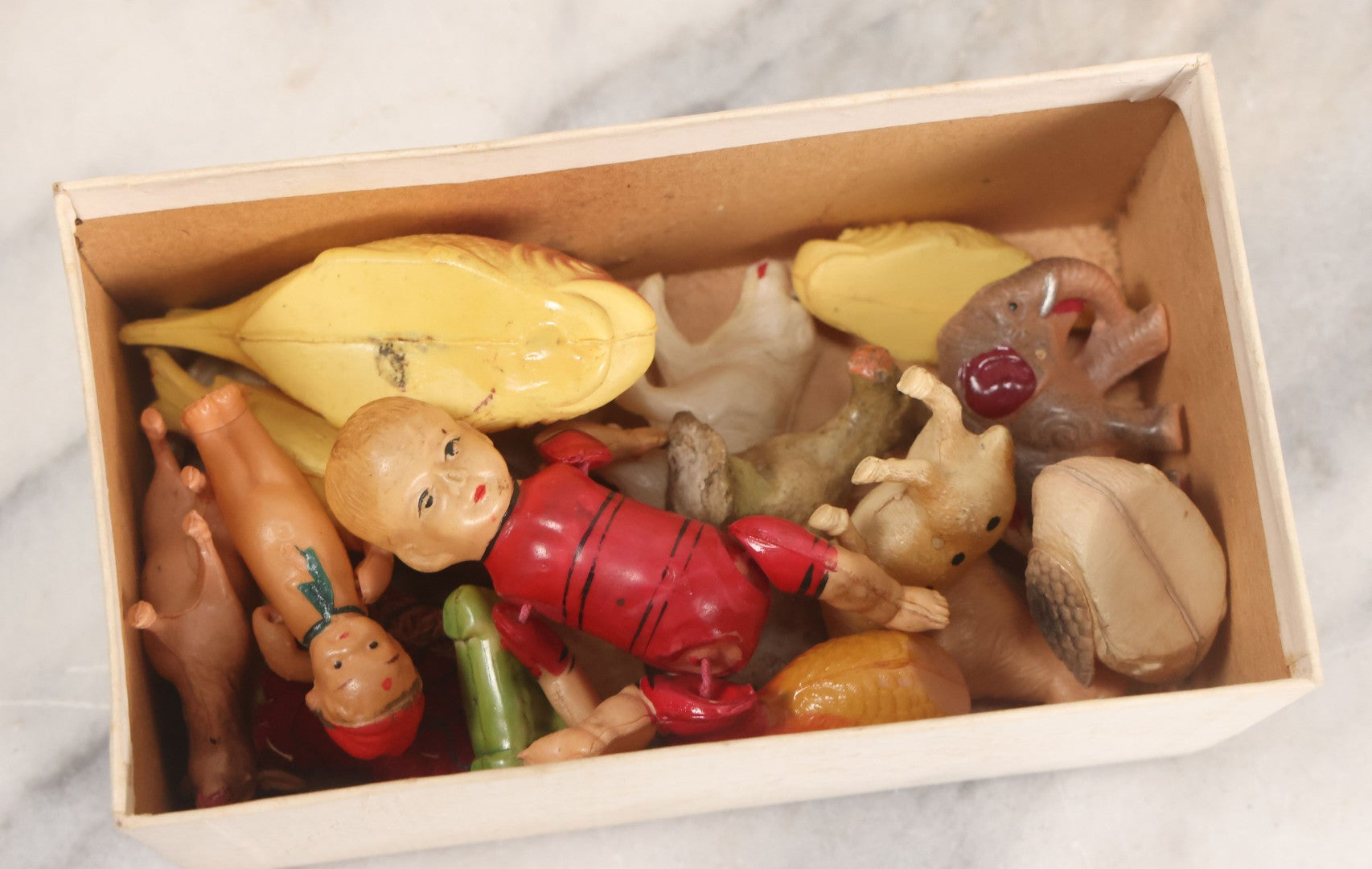Lot 058 - Box Lot Grouping Of 19 Vintage Celluloid Dolls And Animal Toys Including Hippo, Elephant, Polar Bear, Camel, Donkey, Fish, And More