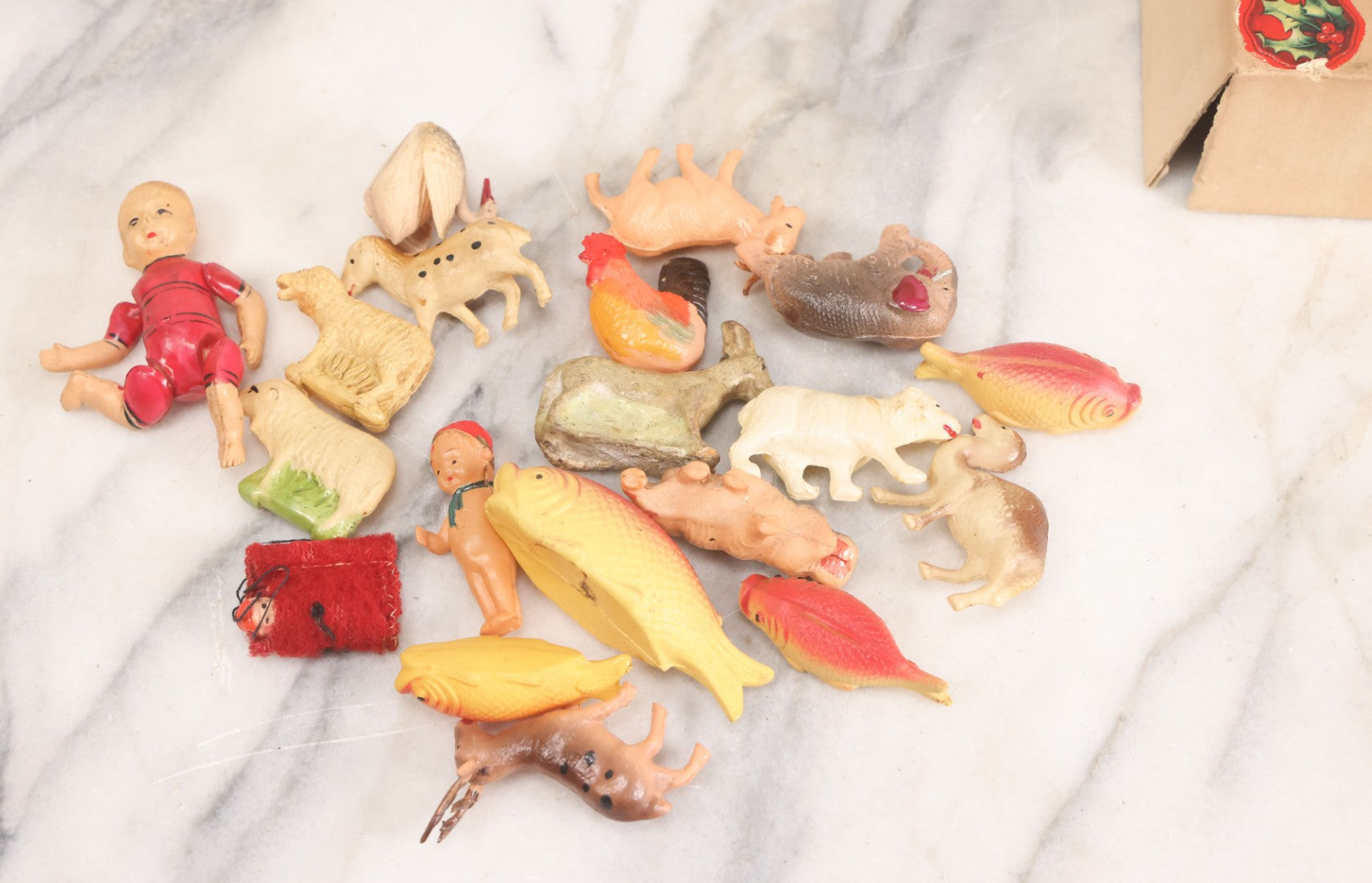 Lot 058 - Box Lot Grouping Of 19 Vintage Celluloid Dolls And Animal Toys Including Hippo, Elephant, Polar Bear, Camel, Donkey, Fish, And More