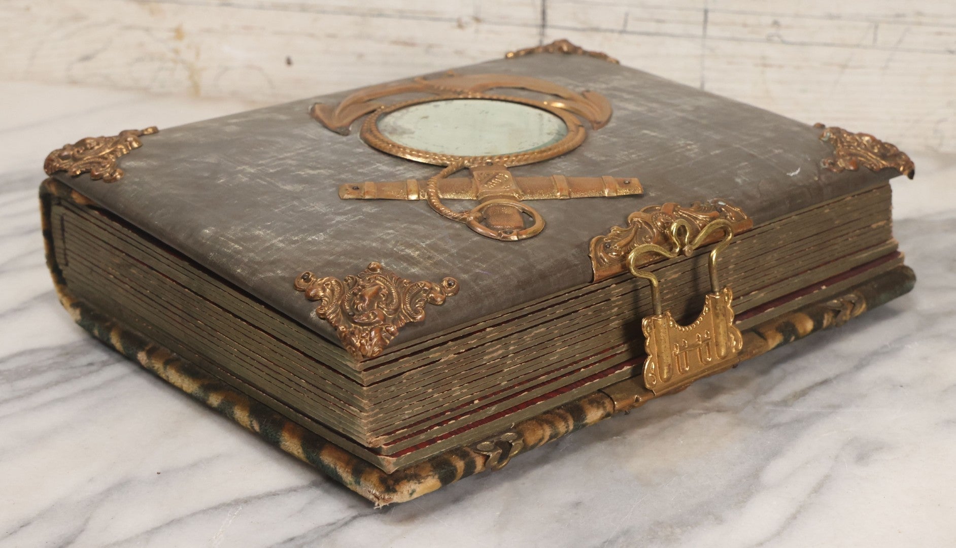 Lot 061 - Antique Victorian Photo Album With Tin Cover And Pressed Brass Anchor "Hope" Motif With Worn Beveled Glass Mirror, And Green Velvet Backing Containing 40+ Cabinet Card And Other Photographs