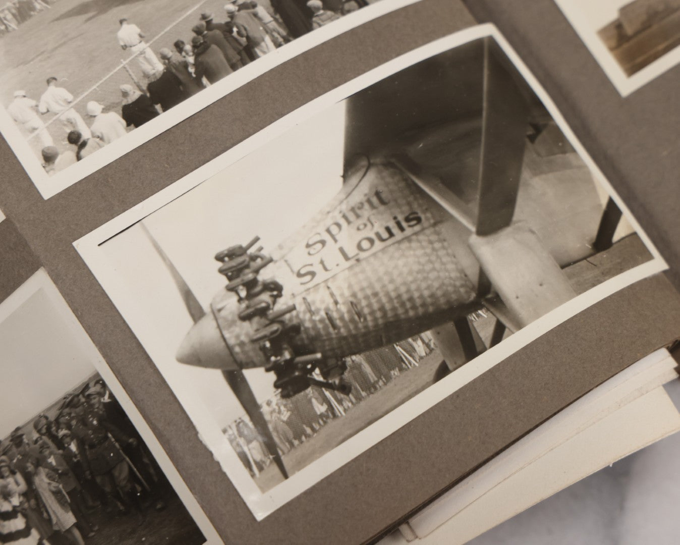 Lot 062 - Vintage Snapshot Photo Album With 125+ Photographs Including Photos Of Spirit Of St. Louis Plane, Redwood Forest, Automobiles, Outings, Comic Wedding Posters, Statue Of Liberty, Beachwear, And More