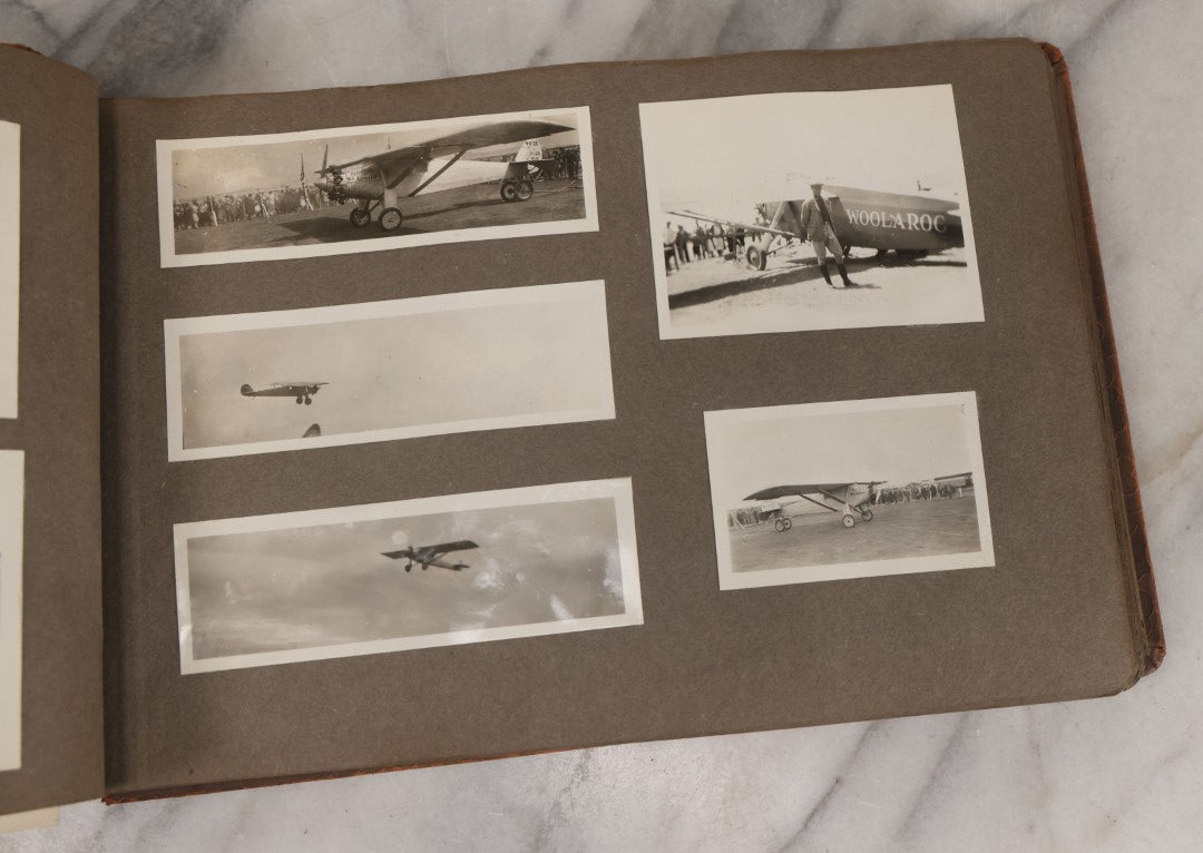 Lot 062 - Vintage Snapshot Photo Album With 125+ Photographs Including Photos Of Spirit Of St. Louis Plane, Redwood Forest, Automobiles, Outings, Comic Wedding Posters, Statue Of Liberty, Beachwear, And More