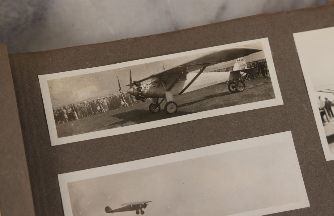 Lot 062 - Vintage Snapshot Photo Album With 125+ Photographs Including Photos Of Spirit Of St. Louis Plane, Redwood Forest, Automobiles, Outings, Comic Wedding Posters, Statue Of Liberty, Beachwear, And More