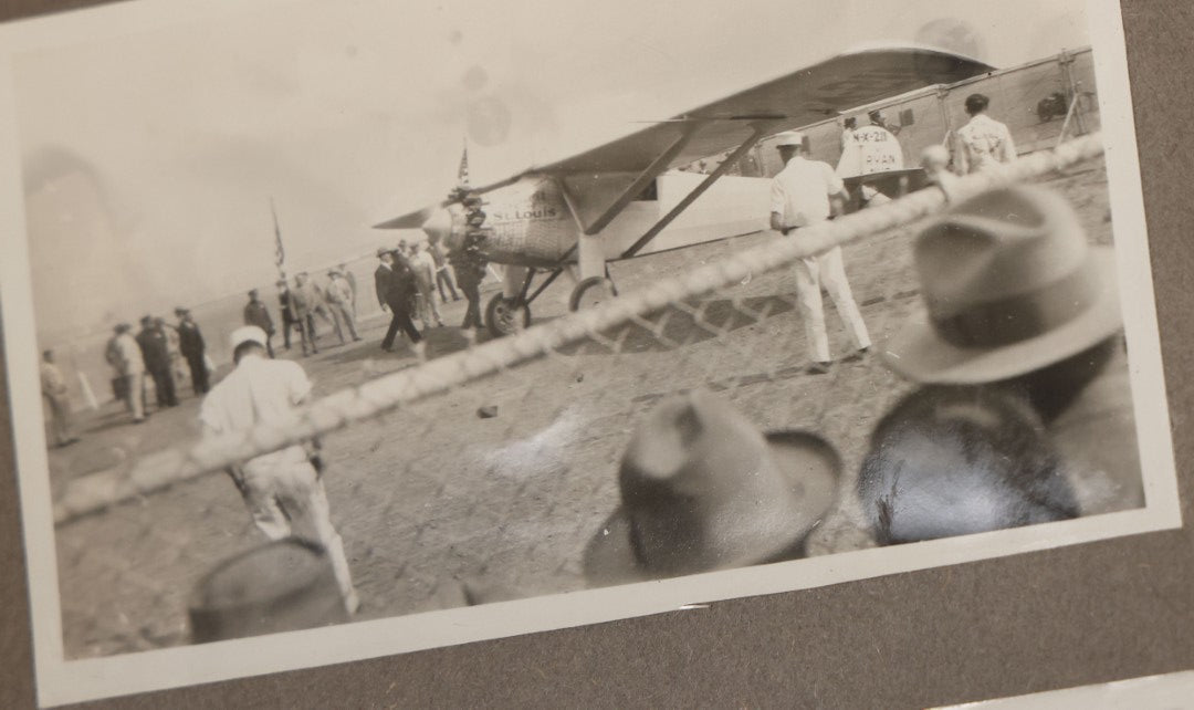 Lot 062 - Vintage Snapshot Photo Album With 125+ Photographs Including Photos Of Spirit Of St. Louis Plane, Redwood Forest, Automobiles, Outings, Comic Wedding Posters, Statue Of Liberty, Beachwear, And More