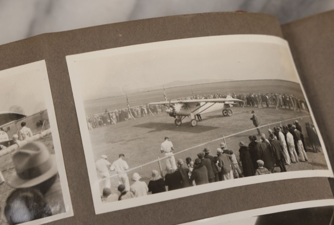 Lot 062 - Vintage Snapshot Photo Album With 125+ Photographs Including Photos Of Spirit Of St. Louis Plane, Redwood Forest, Automobiles, Outings, Comic Wedding Posters, Statue Of Liberty, Beachwear, And More