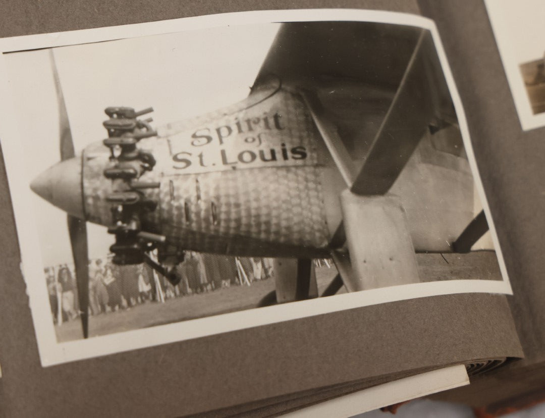 Lot 062 - Vintage Snapshot Photo Album With 125+ Photographs Including Photos Of Spirit Of St. Louis Plane, Redwood Forest, Automobiles, Outings, Comic Wedding Posters, Statue Of Liberty, Beachwear, And More
