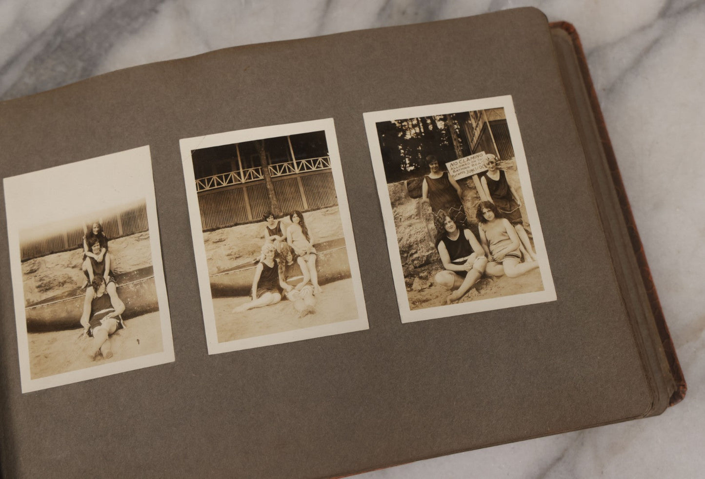 Lot 062 - Vintage Snapshot Photo Album With 125+ Photographs Including Photos Of Spirit Of St. Louis Plane, Redwood Forest, Automobiles, Outings, Comic Wedding Posters, Statue Of Liberty, Beachwear, And More