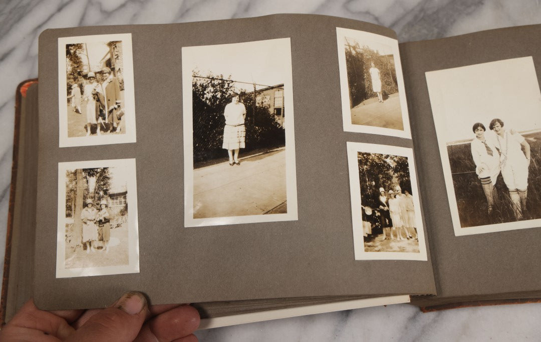 Lot 062 - Vintage Snapshot Photo Album With 125+ Photographs Including Photos Of Spirit Of St. Louis Plane, Redwood Forest, Automobiles, Outings, Comic Wedding Posters, Statue Of Liberty, Beachwear, And More