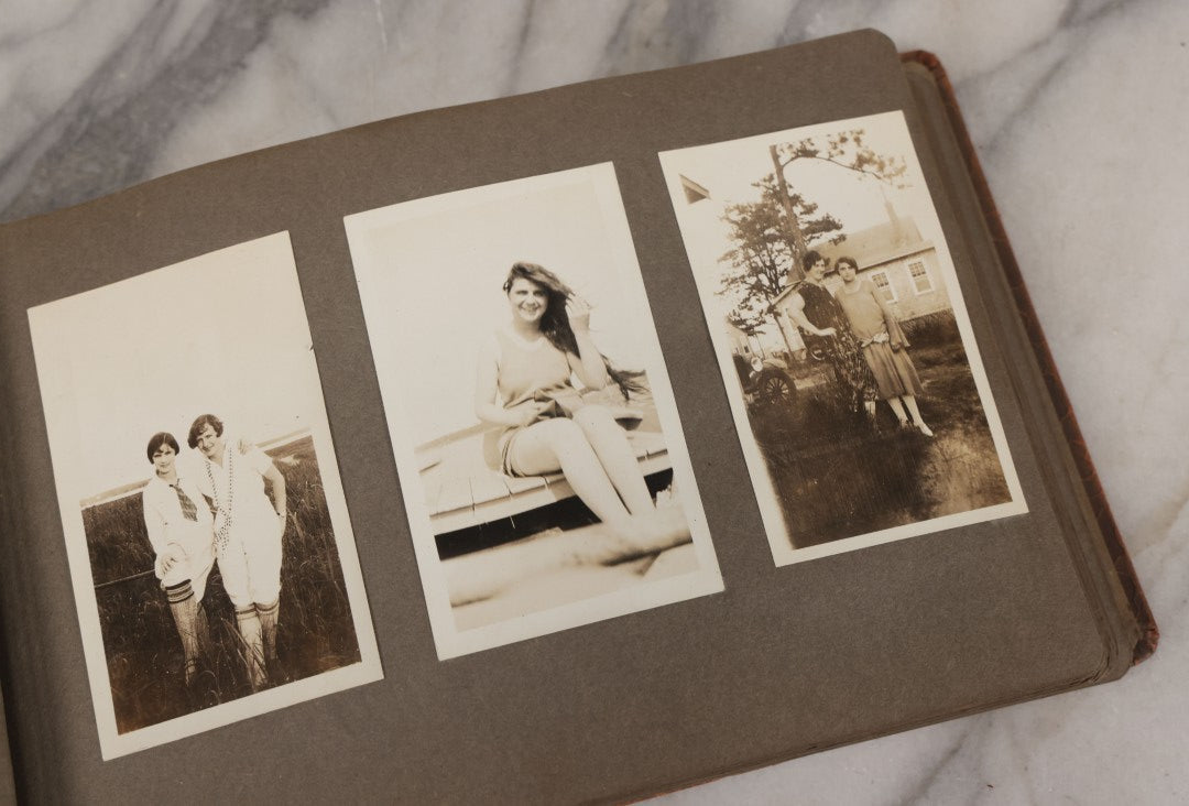 Lot 062 - Vintage Snapshot Photo Album With 125+ Photographs Including Photos Of Spirit Of St. Louis Plane, Redwood Forest, Automobiles, Outings, Comic Wedding Posters, Statue Of Liberty, Beachwear, And More
